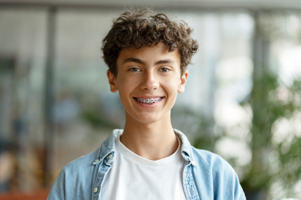 Closeup,Portrait,Of,Smiling,Smart,Curly,Haired,School,Boy,Wearing